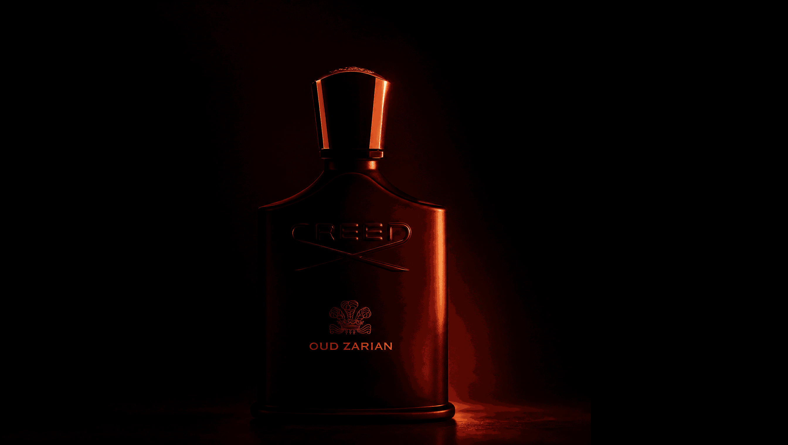 Creed Oud Zarian bottle lit in deep red against black