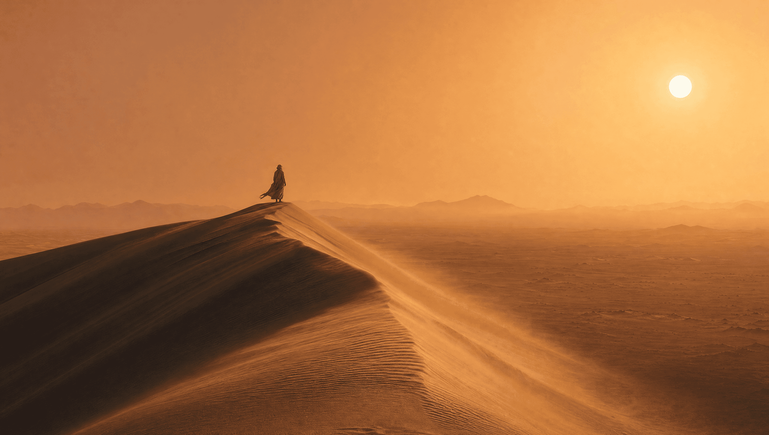 Lone figure on a desert dune ridge at golden hour